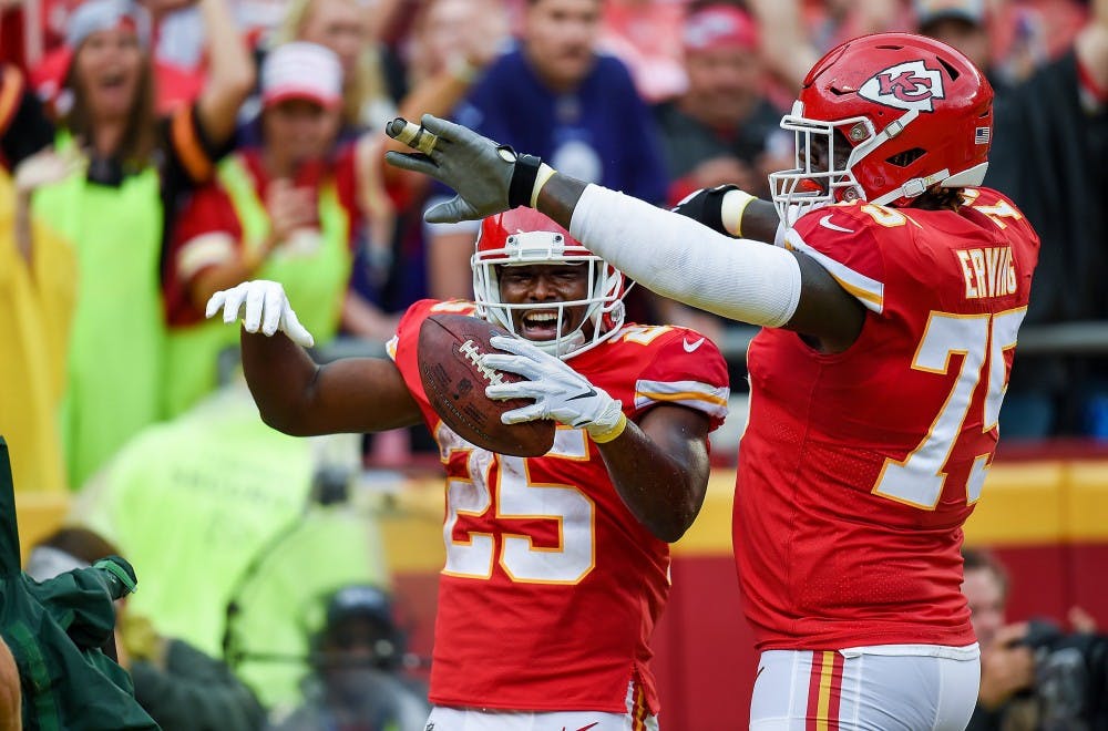 Chiefs running back  LeSean McCoy (25) celebrates his touchdown with teammate Cam Erving (75) during the third during the home opener Sunday, September 22, 2019, at Arrowhead Stadium  in Kansas City, Mo. McCoy scored on 14-yard catch on a pass from quarterback Patrick Mahomes. (Tammy Ljungblad/The Kansas City Star/TNS)