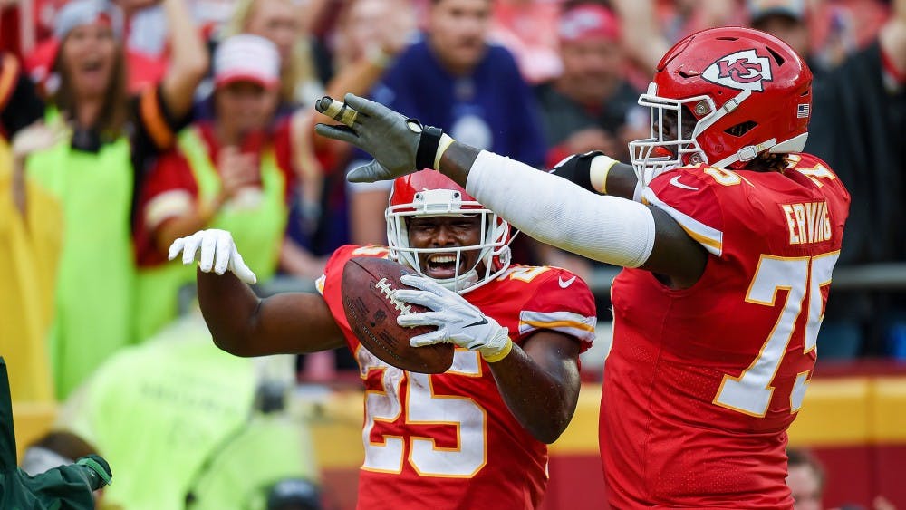 Chiefs running back  LeSean McCoy (25) celebrates his touchdown with teammate Cam Erving (75) during the third during the home opener Sunday, September 22, 2019, at Arrowhead Stadium  in Kansas City, Mo. McCoy scored on 14-yard catch on a pass from quarterback Patrick Mahomes. (Tammy Ljungblad/The Kansas City Star/TNS)