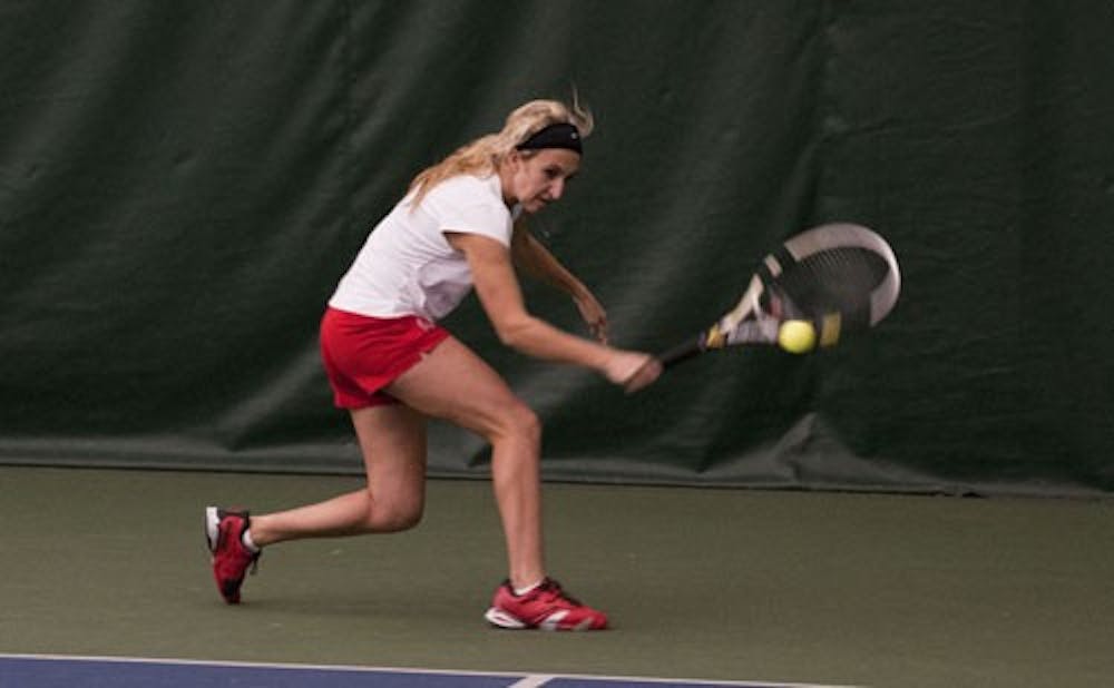 Sohpomore Courtney Wild returns a volley during her singles match. DN PHOTO BOBBY ELLIS