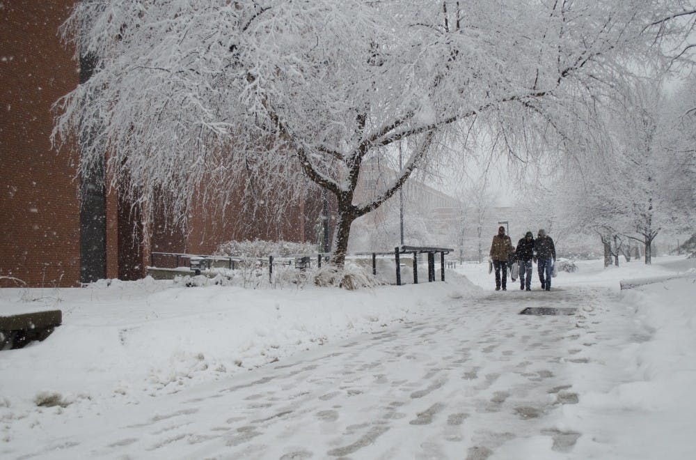 Students walk past Bracken Library as it continues snow Jan. 5. Twenty tons of salt were used around campus, said Kevin Kenyon, associate vice president of facilities. DN FILE PHOTO BREANNA DAUGHERTY