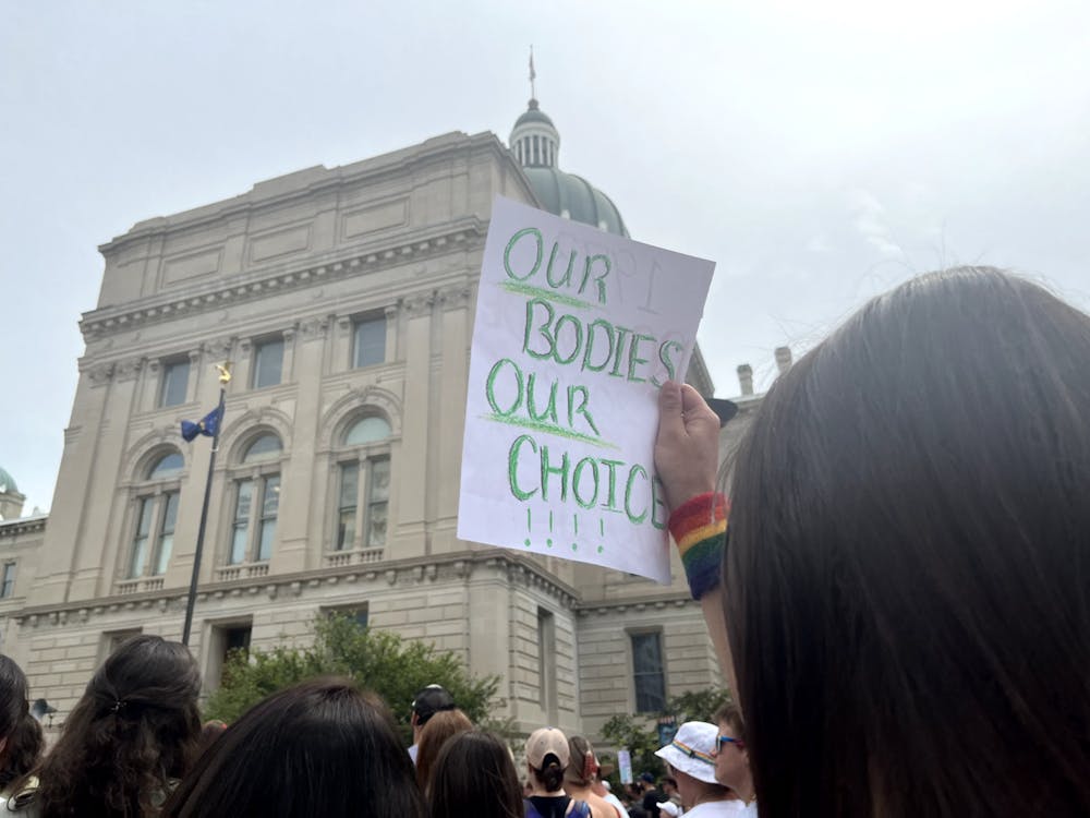 A protester holds up a sign reading, "Our Bodies, Our Choice" outside the Indiana Capital Building in Indianapolis, Indiana. A bill to outlaw abortion (with limited exceptions) in Indiana is set to be passed Sept. 15 