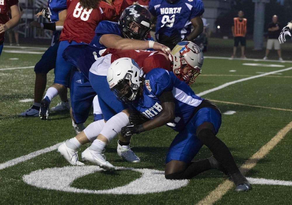 North cornerback Josiah Ullom helps tackle the South runner July 14 during the North/South All-Star Classic at Decatur Cetral High School. Zach Carter, DN.