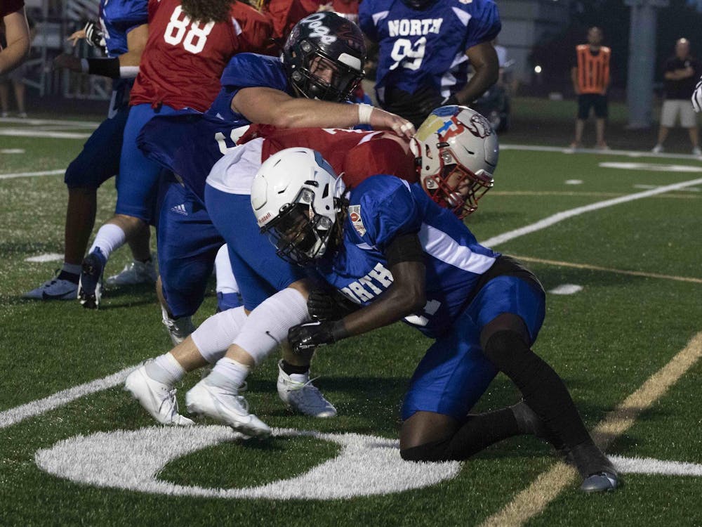 North cornerback Josiah Ullom helps tackle the South runner July 14 during the North/South All-Star Classic at Decatur Cetral High School. Zach Carter, DN.