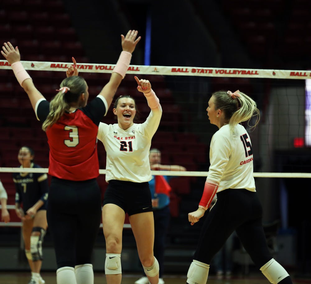 Ball State women's volleyball celebrate scoring a point against Akron Oct. 12 at Worthen Arena. The Cardinals won 3-0 against the Zips. Mya Cataline, DN