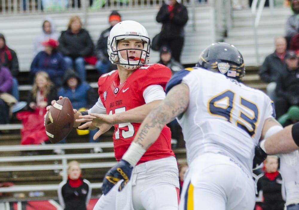 Freshman quarterback Riley Neal looks to a teammate to pass the ball to during the game against Toledo on Oct. 2 at Scheumann Stadium. DN PHOTO BREANNA DAUGHERTY