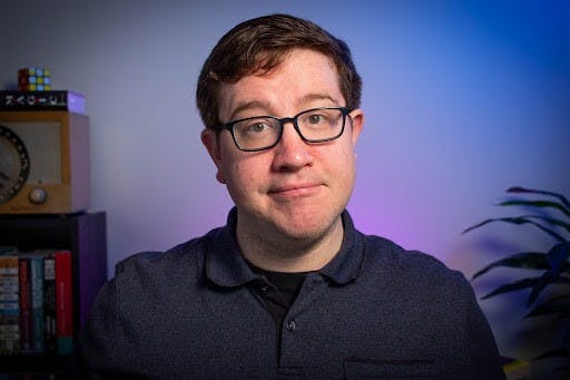 Ball State Assistant Professor of Psychological Science Andy Luttrell poses in his recording space for his podcast “Opinion Science.” The show features guests from across the nation and has experienced a recent growth in listeners. Andy Luttrell, Photo Provided