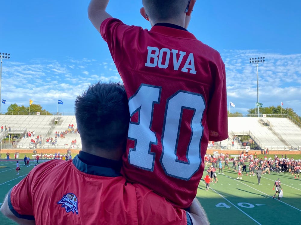 Ball State Alumni Garrett Bova watches Ball State football warm-up with his son Brody Bova on his shoulder Oct.1, 2022 at Scheumann Stadium. Dannie Bova, Photo provided