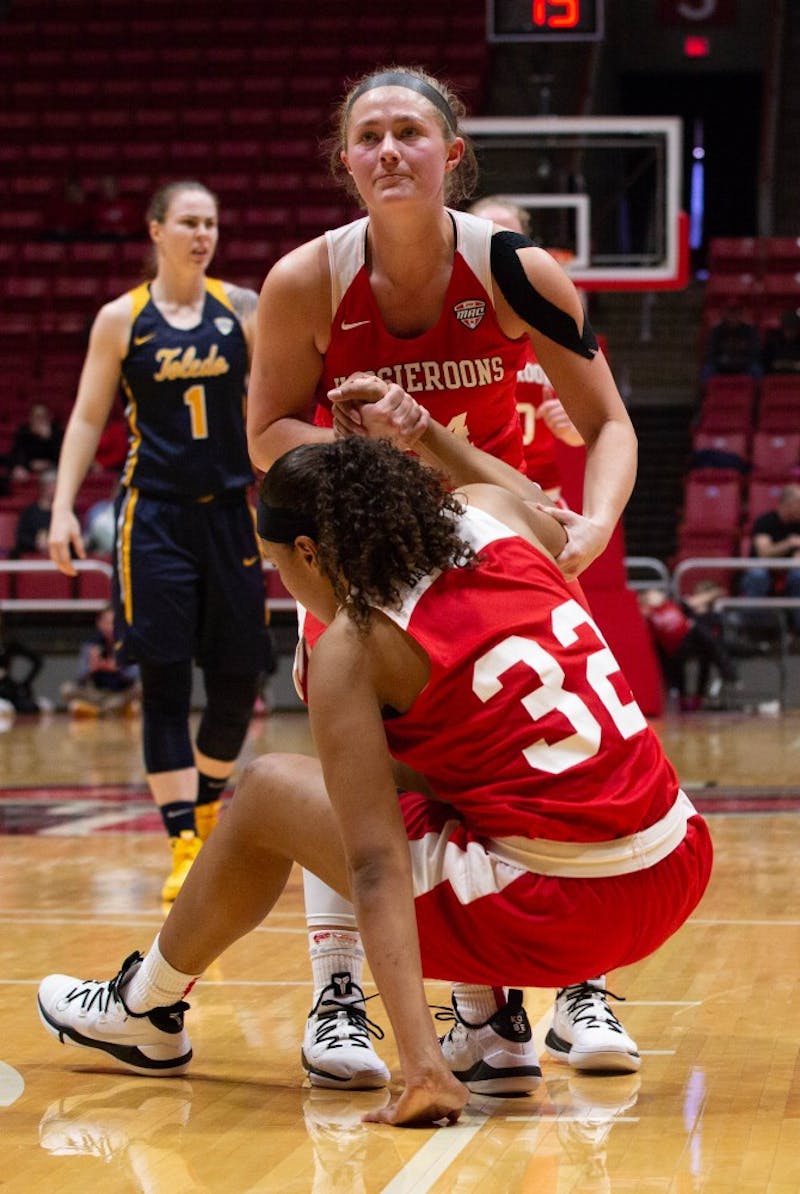 Senior Jasmin Samz helps Sophomore Oshlynn Brown get up during the game against Toledo in John E. Worthen Arena Feb. 23, 2019. The Hoosieroons lost to the Rockets 63-62. Scott Fleener, DN