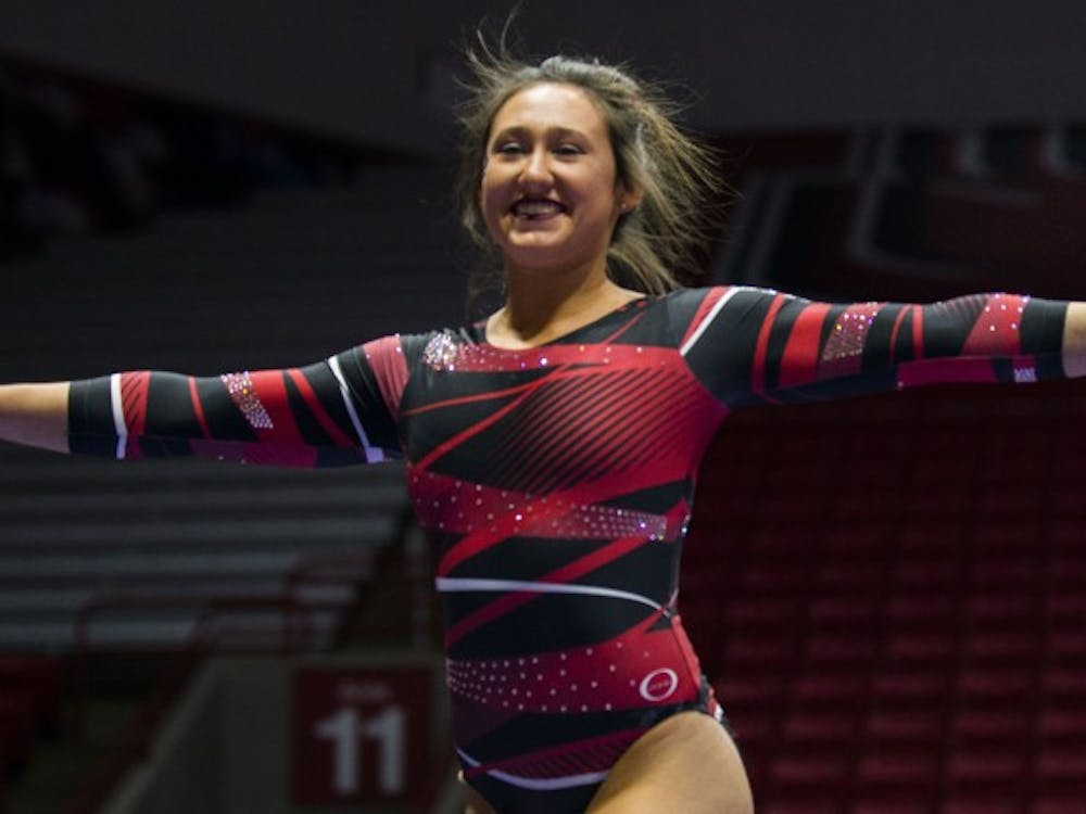Freshman Bri Slonim smiles toward the crowd and judges during her routine on the balance beam during the meet against Northern Illinois on Jan. 15 at Worthen Arena. Slonim places second with a score of 9.725. Breanna Daugherty // DN