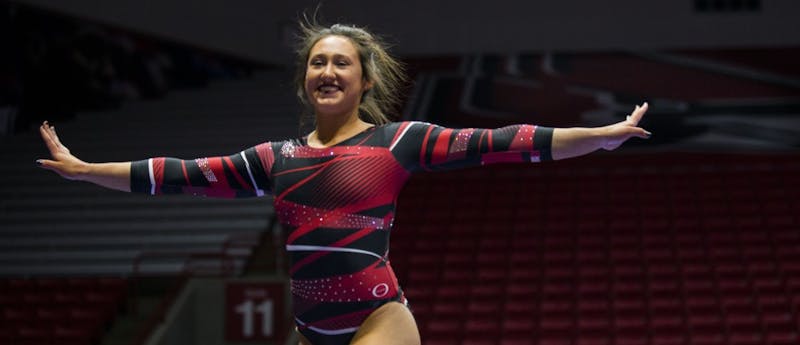 Freshman Bri Slonim smiles toward the crowd and judges during her routine on the balance beam during the meet against Northern Illinois on Jan. 15 at Worthen Arena. Slonim places second with a score of 9.725. Breanna Daugherty // DN