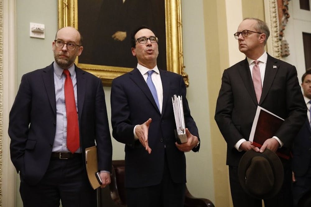 <p>Treasury Secretary Steve Mnuchin, center, speaks with members of the media as he departs a meeting with Senate Republicans on an economic lifeline for Americans affected by the coronavirus outbreak. on Capitol Hill in Washington, Monday, March 16, 2020. <strong>(AP Photo/Patrick Semansky)</strong></p>