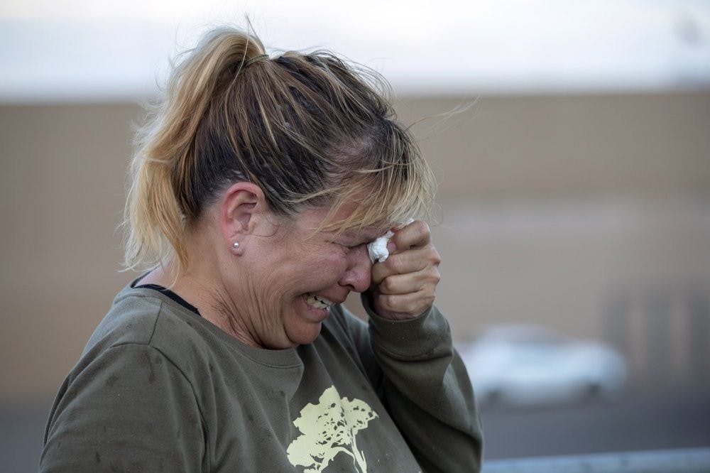 <p>Edie Hallberg cries while speaking to police outside a Walmart store where a shooting occurred earlier in the day as she looks for her missing mother Angie Englisbee, who was in the store during the attack in El Paso, Texas, Saturday, Aug. 3, 2019. Multiple people were killed and one person was in custody after a shooter went on a rampage at a shopping mall, police in the Texas border town of El Paso said. <strong>(AP Photo/Andres Leighton)</strong></p>
