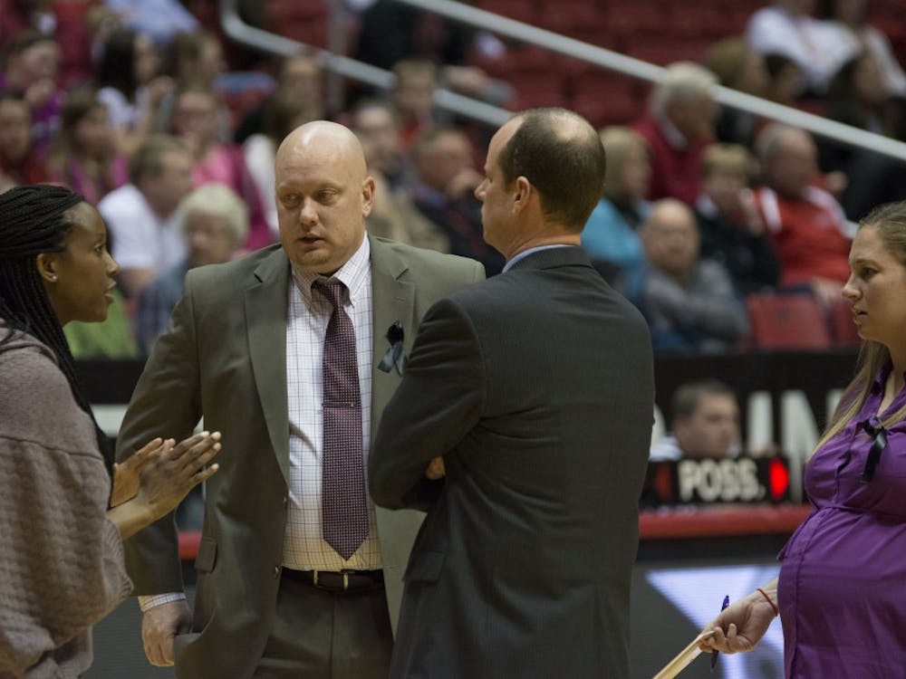 Head coach Brady Sallee speaks with his coaching staff during a time-out at during the game against Eastern Michigan on Feb. 25 at Worthen Arena. DN PHOTO AMER KHUBRANI