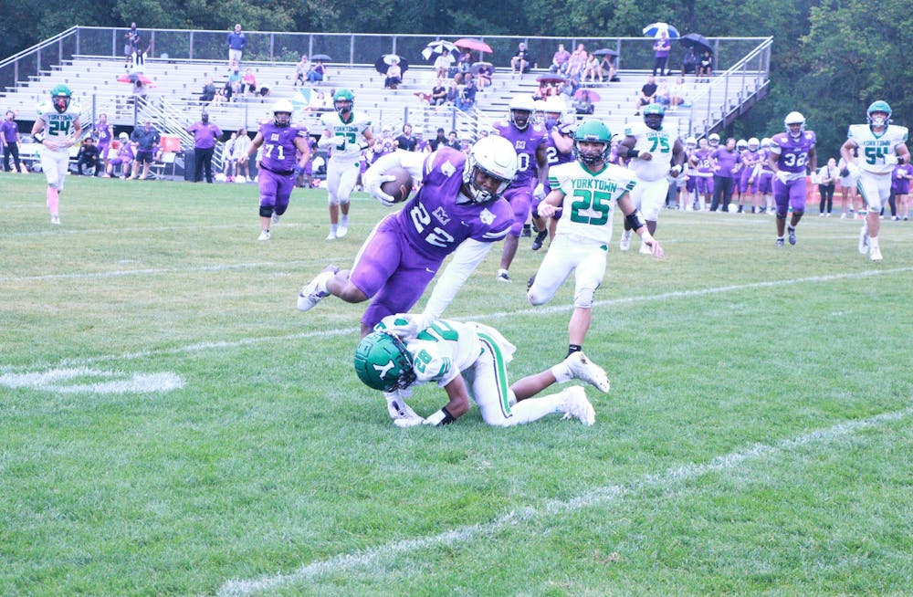 Muncie Central junior Marquis Allen hurdles a tackler Aug. 31 against Yorktown at Yorktown High School. The Tigers won the game 30-14. David Moore, DN.