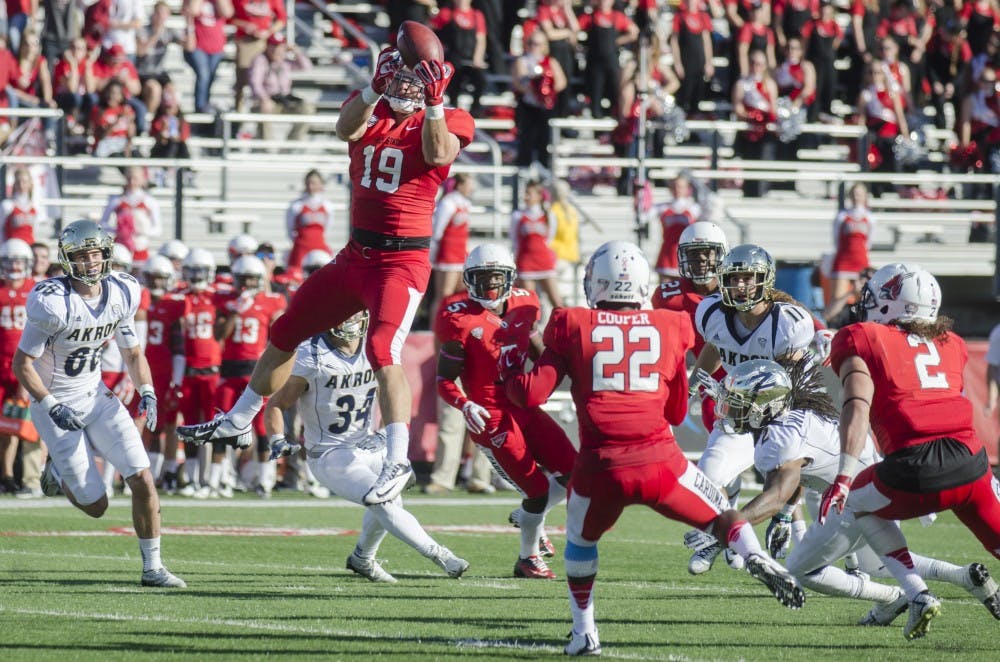 Redshirt junior linebacker Ben Ingle jumps up for an interception during the game against Akron on Oct. 25 at Scheumann Stadium. DN PHOTO BREANNA DAUGHERTY