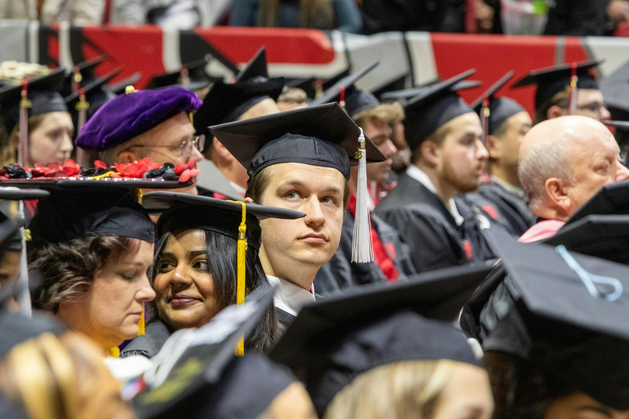 A graduate looks up to the crowd before walking at Fall Commencement Dec. 16 at Worthen Arena. Ball State conferred more than 1,200 doctoral, specialist, master’s and baccalaureate degrees during the ceremony. Daniel Kehn, DN