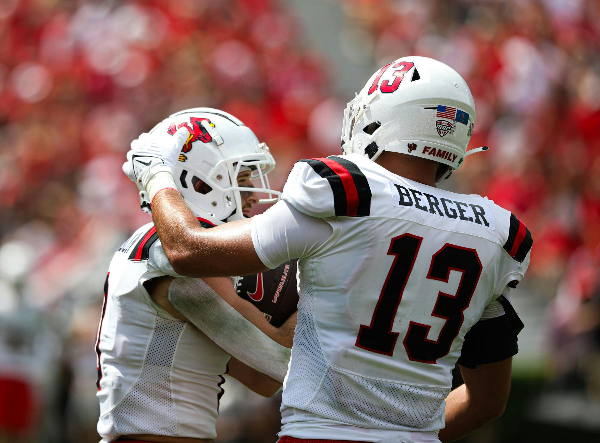 Junior linebacker Brandon Berger rubs the helmet of redshirt freshman Nick Munson Sept. 9 at Sanford Stadium in Athens, Ga. Kate Farr, DN