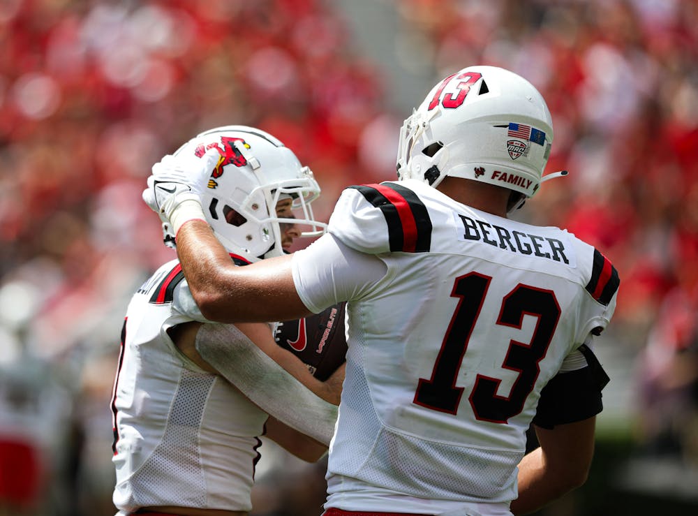 Junior linebacker Brandon Berger rubs the helmet of redshirt freshman Nick Munson Sept. 9 at Sanford Stadium in Athens, Ga. Kate Farr, DN