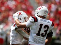 Junior linebacker Brandon Berger rubs the helmet of redshirt freshman Nick Munson Sept. 9 at Sanford Stadium in Athens, Ga. Kate Farr, DN