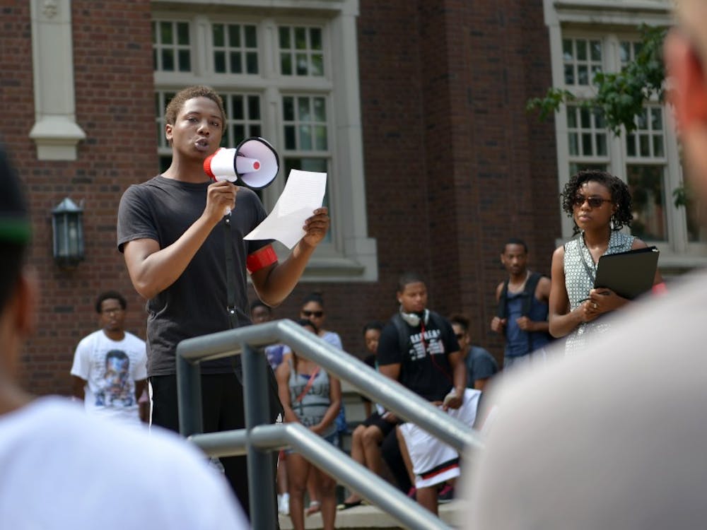 Sophomore acting major Keith Overall are from Ferguson. He gives a speech at the beginning of the protest Sunday afternoon at North Quad. DN PHOTO SICONG XING