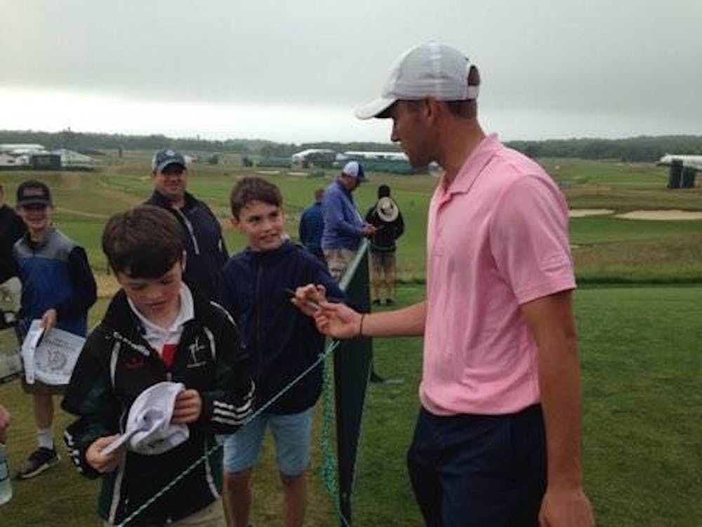 <p>Timothy Wiseman signs autographs for fans at the U.S. Open. Wiseman is the first Ball State golfer to qualify for a major tournament while still in school. <strong>Timothy Wiseman, Photo Provided</strong></p>