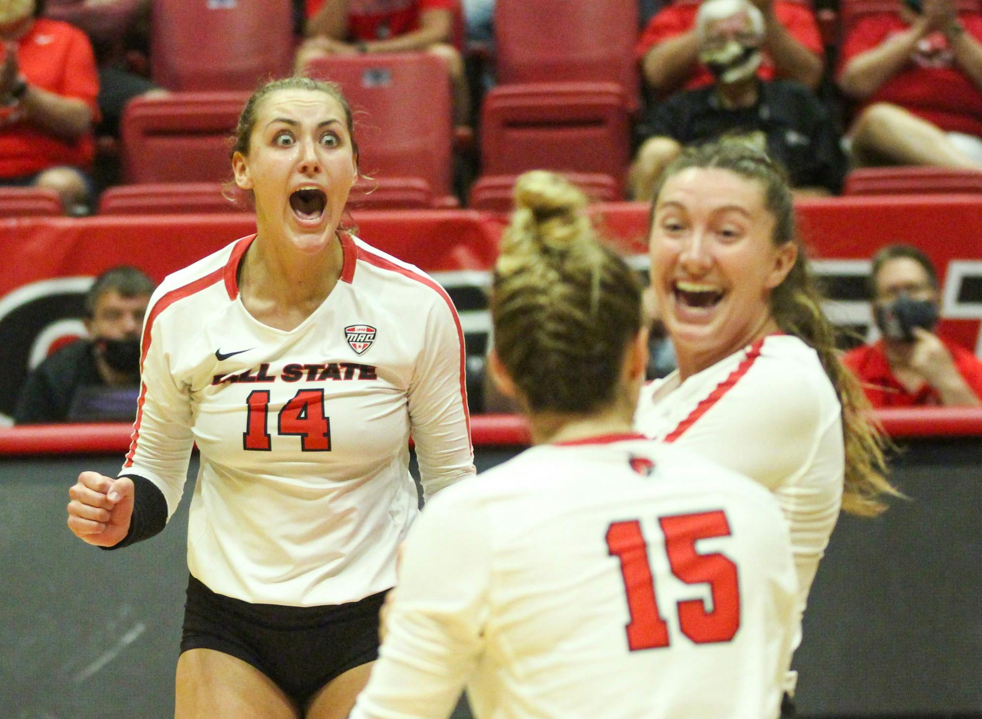 5th year outside hitter Emily Hollowell (left), junior middle blocker Marie Plitt (right), and freshman setter Megan Wielonski celebrate a block by Wielonski. Ball State will take on Ohio in Worthen Arena Sept. 30. Jacy Bradley, DN