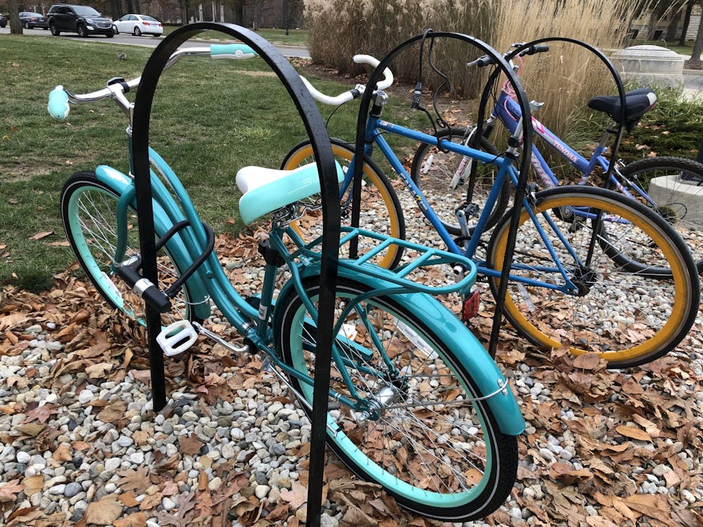 A light blue bike is locked Nov. 22, 2019, outside the L.A. Pittenger Student Center with a U-lock. University Police Department Corporal Travis Stephens recommends using a U-lock or other quality style locks and properly locking the bike to a bike rack to prevent theft. Grace McCormick, DN
