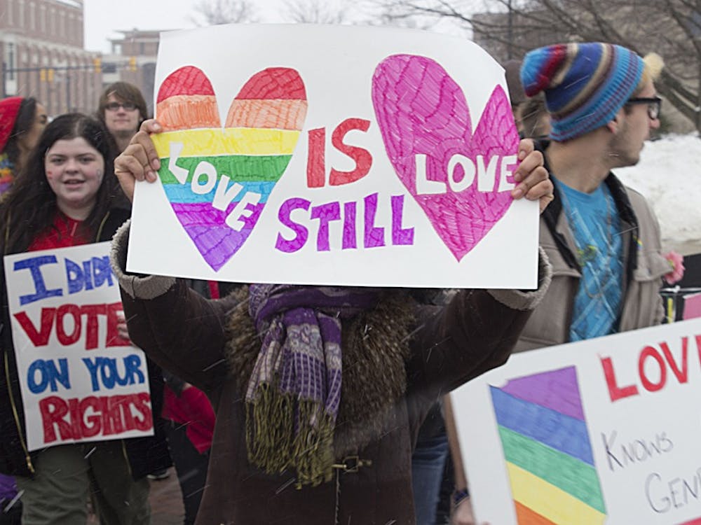 A student holds a sign reading "love is still love" during a protest on Feb. 14. The protest sought to bring attention to the issue of marriage equality. DN PHOTO ANDREW KELLY