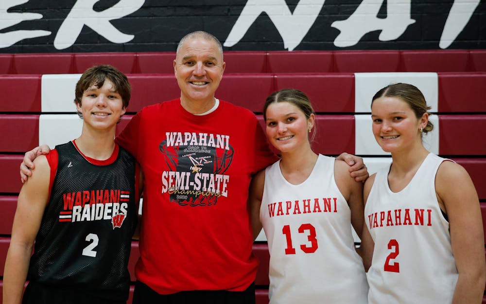 The Luce family poses for a photo during a Wapahani basketball practice Feb. 5 at Wapahani High School. While the family loves basketball, Nate said he and Matt are pretty good at ending the basketball mindset once they leave the Wapahani gym. Andrew Berger, DN 
