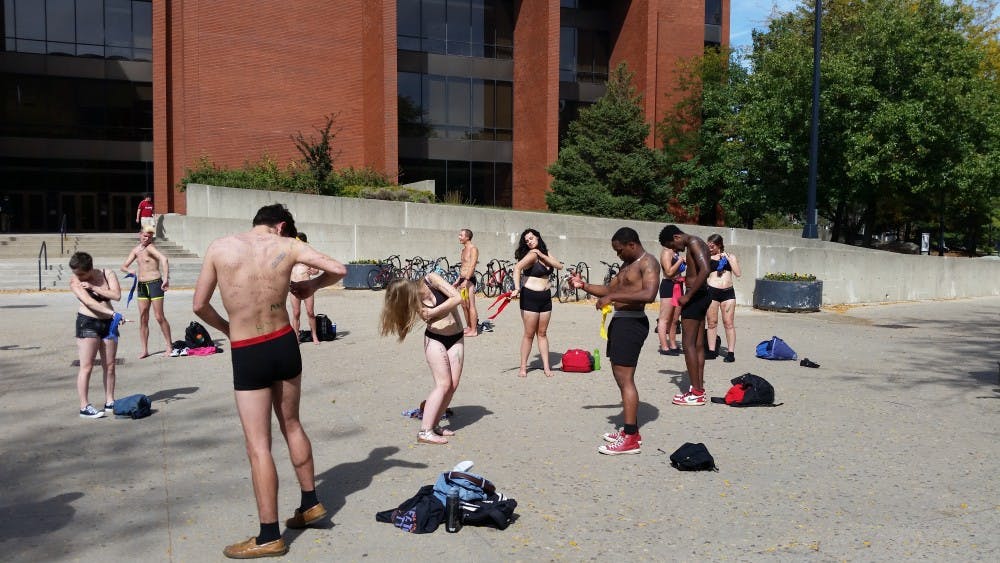 <p>For Diversity Day, 21 men and women stood between Bracken Library and University Theatre on Sept. 25 where they striped down to their undergarments. The students were part of a Living Museum put on by the Ethnic Theatre Allicance. <em>DN PHOTO ALAN HOVORKA</em> </p>