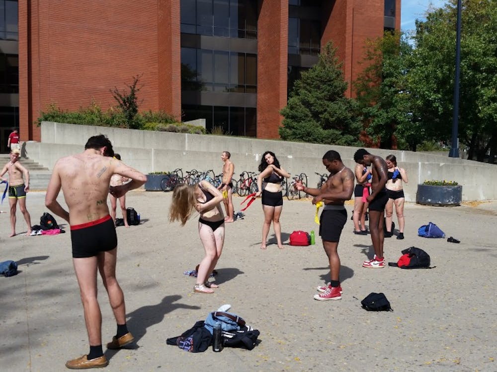 For Diversity Day, 21 men and women stood between Bracken Library and University Theatre on Sept. 25 where they striped down to their undergarments. The students were part of a Living Museum put on by the Ethnic Theatre Allicance. DN PHOTO ALAN HOVORKA 
