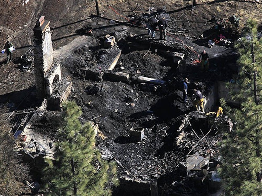 Investigators process the scene and identify the human remains found in the charred cabin on Wednesday, February 13, 2013, where fugitive ex–cop Christopher Dorner was believed to have been holed up after trading gunfire overnight with officers. (Brian Vander Brug/Los Angeles Times/MCT)