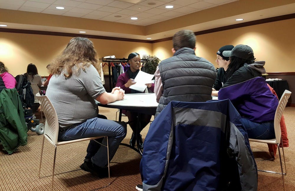 <p>One of five tables in the forum room talks about disability awareness on campus at a Beneficence Dialogue in the L.A. Pittenger Student Center March 1. <strong>Sara Barker, DN</strong></p>