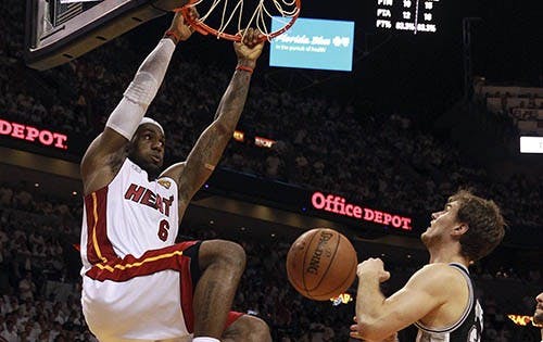 The Miami Heat’s LeBron James scores in the fourth quarter against the San Antonio Spurs on Tuesday in Miami, Fla. Miami won 103-100 in overtime to force a Game 7. MCT PHOTO