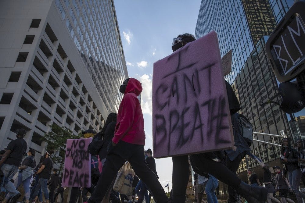 Protestors rally in downtown Indianapolis on Saturday, May 30, 2020. Protests were held in U.S. cities over the death of George Floyd, a black man who died after being restrained by Minneapolis police officers on May 25. (Mykal McEldowney/The Indianapolis Star via AP)