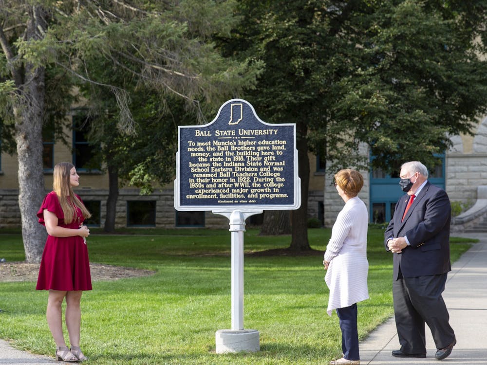 Ball State Board of Trustees Student Member Amy Wyse reads the new historical marker during the unveiling ceremony Sept. 30, 2021. The marker celebrates Ball State&#x27;s centennial, achieved in 2018. Eli Houser, DN