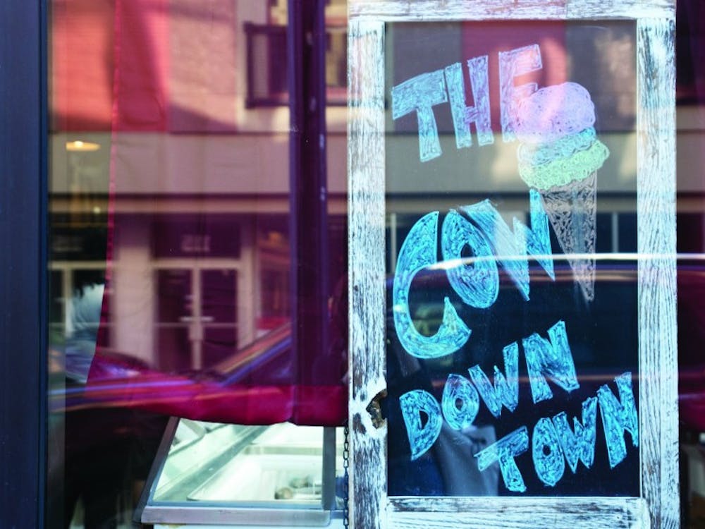 A sign in the window of The Barking Cow displays the ice cream shop’s nickname, “The Cow Downtown.” Manager Danielle Woodson gave this nickname to The Barking Cow because in Gaston, locals call the ice cream shop, “The Cow.” Pauleina Brunnemer, DN