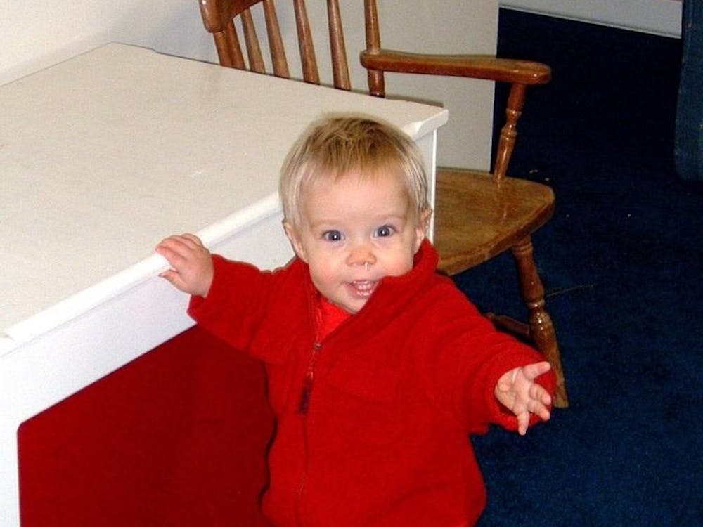 Daniel Kehn props himself up on a toy trunk in his childhood home. Daniel Kehn, Photo Provided