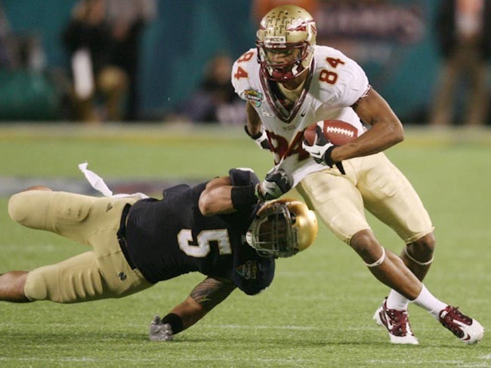 Florida State wide receiver Rodney Smith (84) runs past Notre Dame linebacker Manti Te'o (5) after a pass reception during the Champs Sports Bowl at the Florida Citrus Bowl in Orlando, Florida, on Thursday, December 29, 2011. Florida State won, 18-14. (Stephen M. Dowell/Orlando Sentinel/MCT)