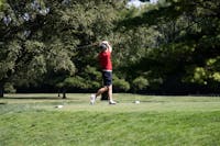 Sophomore Carter Smith drives the ball at the Earl Yestingsmeier Invitational at the Delaware Country Club Sept. 10. The Cardinals claimed the team championship. Aulani Ho, DN