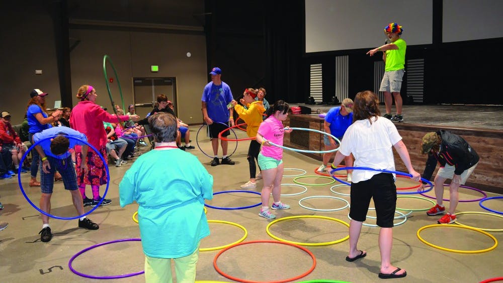 Camp ReYoAd campers play a game with hoola hoops in the recreational room during summer 2018. Camp ReYoAd provides summer experiences for individuals with special needs aged 16 and older. Molly Boylan, photo provided.