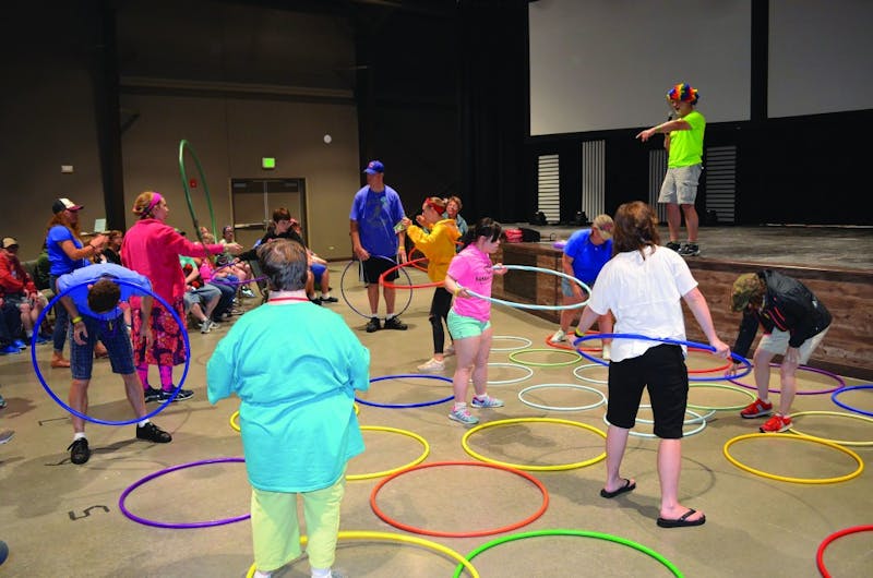 Camp ReYoAd campers play a game with hoola hoops in the recreational room during summer 2018. Camp ReYoAd provides summer experiences for individuals with special needs aged 16 and older. Molly Boylan, photo provided.