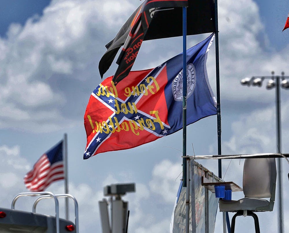 Flags fly at Daytona International Speedway, including a variation of a confederate/Georgia state flag, ahead of the Coke Zero 400 at Daytona International Speedway on Friday, July 3, 2015, in Daytona Beach, Fla. (Joe Burbank/Orlando Sentinel/TNS)