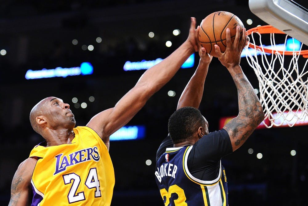 The Los Angeles Lakers' Kobe Bryant (24) blocks a shot by Trevor Booker of the Utah Jazz in the first half on Wednesday, April 13, 2016, at Staples Center in Los Angeles. (Wally Skalij/Los Angeles Times/TNS)