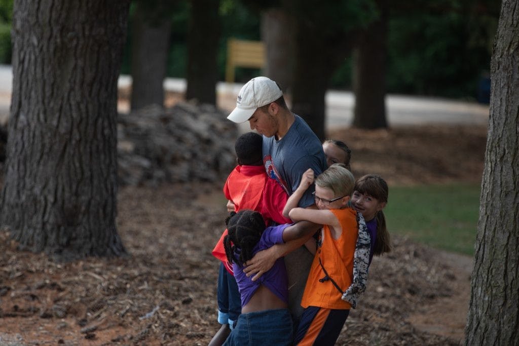 A Camp Adventure counselor interacting with camp attendees. Camp Adventure is a no-cost four-day day camp for Muncie area third graders. Ball State University, photo courtesy