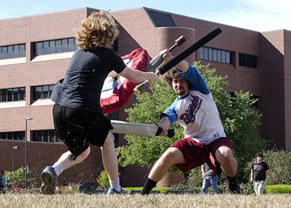 Jackson Eflin, a senior creative writing major, left, fights with sophomore computer science major Bradford Barclay on the University Green on Sept. 4 in a game of Dag.  DN PHOTO BREANNA DAUGHERTY