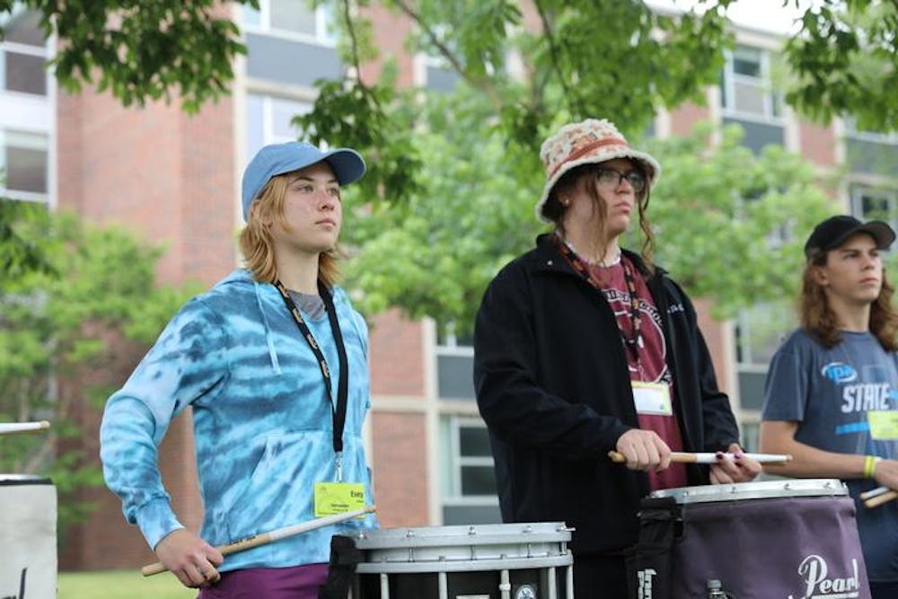 Evey Arleth waits for instruction from her group's team leader during a rehearsal at Music For All Summer Symposium, June 27, 2023. Several hundred students from across the country converged on Ball State's campus for the weeklong event that included not just musical instruction, but games and other team-building events. Madelyn Moore, DN