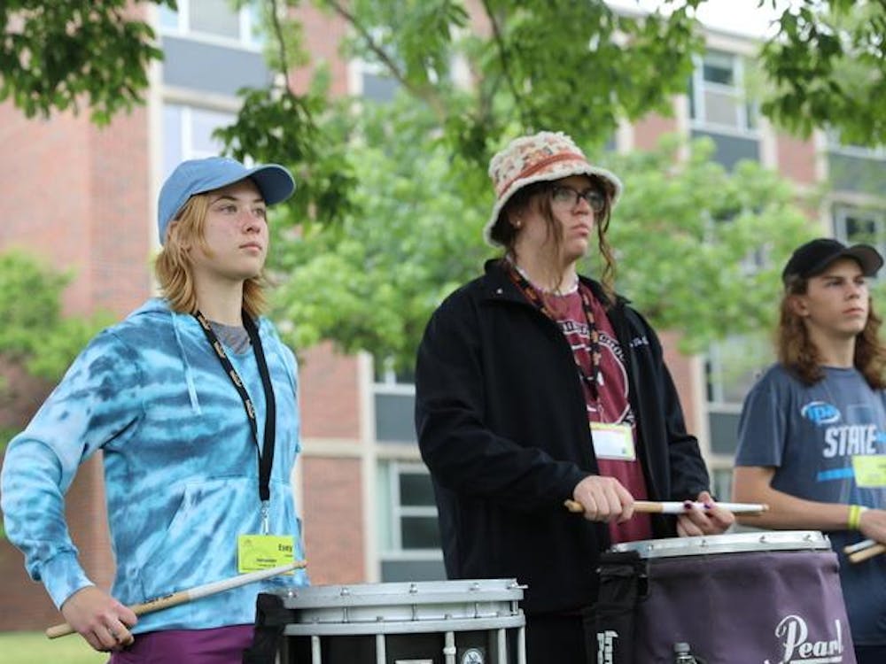 Evey Arleth waits for instruction from her group's team leader during a rehearsal at Music For All Summer Symposium, June 27, 2023. Several hundred students from across the country converged on Ball State's campus for the weeklong event that included not just musical instruction, but games and other team-building events. Madelyn Moore, DN