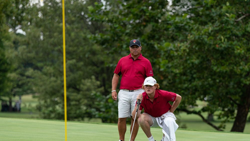 Ball State Men's Golf Head Coach Mike Fleck (left) and sophomore Kash Bellar look for a shot on the green of hole eleven of the Earl Yestingmeier Invite Sep. 3 at the Delaware Country Club. Hosted by the Delaware Country Club, the 2022 Earl Yestingsmeire Invite had 15 teams from schools across the region competing on the par-70 course. Eli Houser, DN