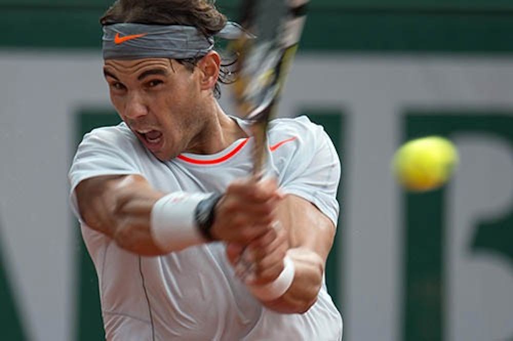 Rafael Nadal hits a shot against Italy's Fabio Fognini during third-round action in the French Tennis Open 2013 in Paris June 1. Nadal took home his 8th French Open victory of his career. MCT PHOTO